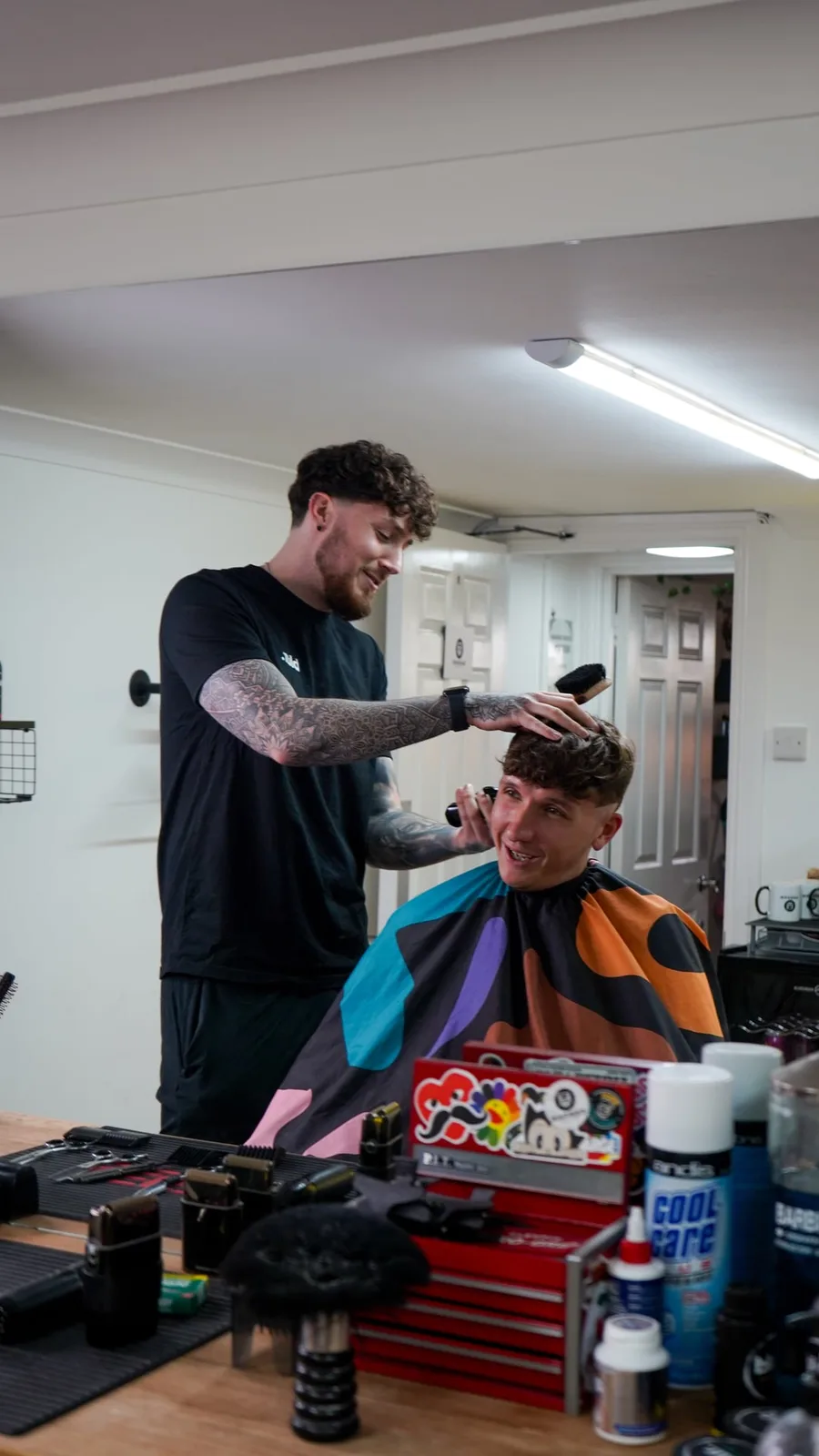 Callum Warnes finishing a client's cut at Barber Warnz